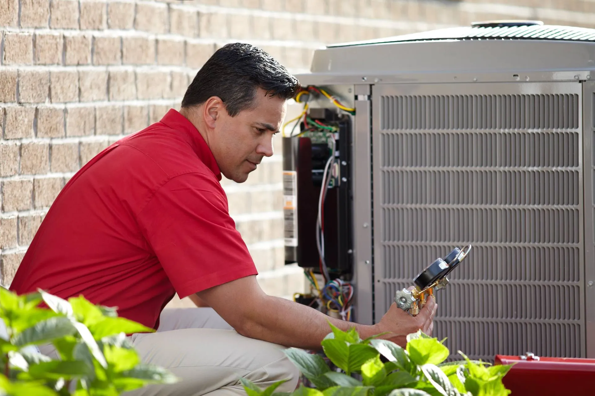 NW Mechanical technician diagnosing a residential air conditioner at a Seattle area home